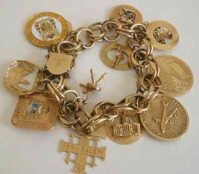 Vintage Estate Charm Bracelet with 11 14K Yellow Gold Charms .