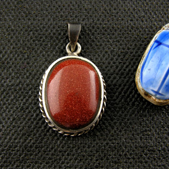 Silver pendant with dark red stone & filigree border (jewelry .