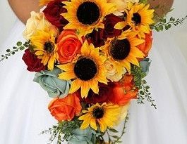 Cascading wedding flower brides bouquet with sunflowers, orange .