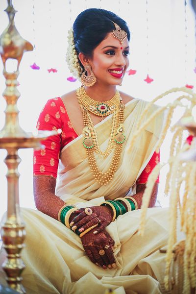 Malayalam Brides - Bride in a White and Gold Kanjivaram Saree with .